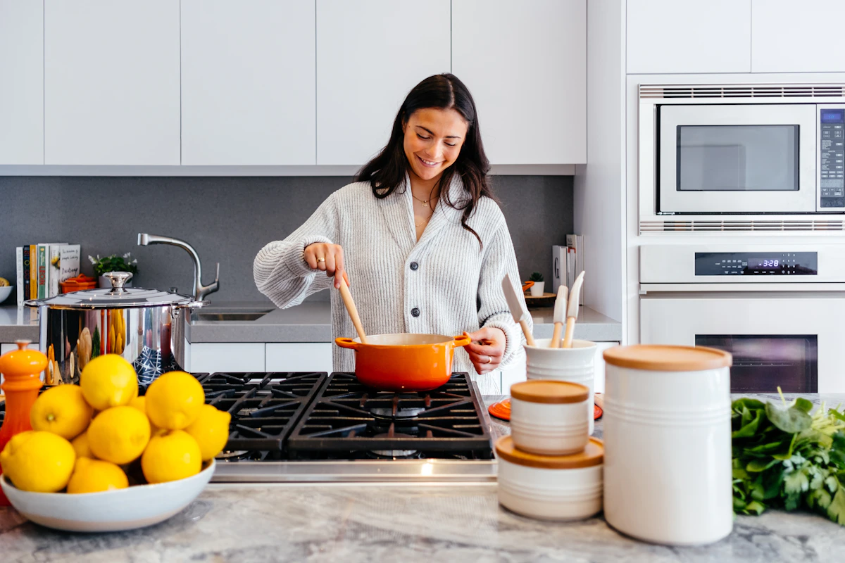 A sunlit, spotless modern kitchen with fresh seasonal branches after a Havenly spring deep clean